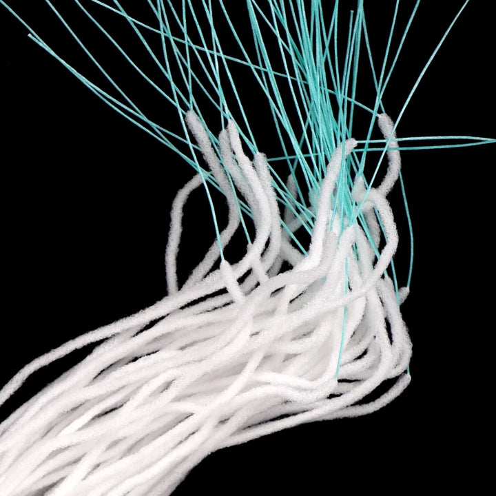 Close-up of the join between the white fluffy section and the turquoise tip of the strands