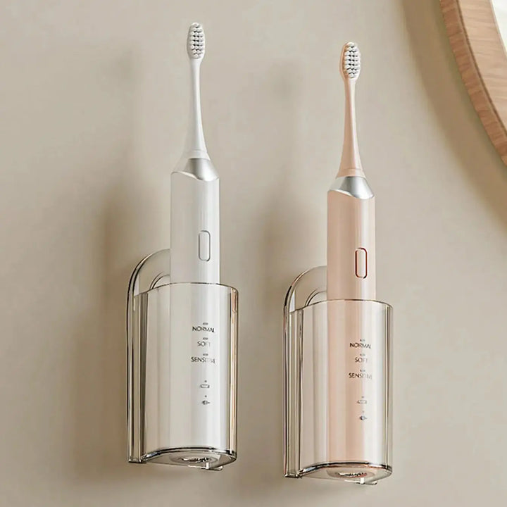 Two clear wall holders, each holding an electric toothbrush upright