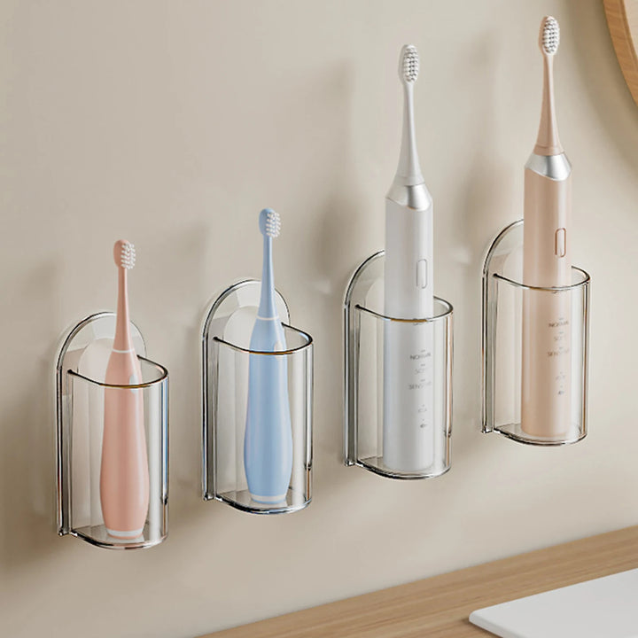 Four holders in a row on the wall, with electric toothbrushes of different sizes