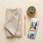 Soft kids’ toothbrushes — flat lay on a cream background, minimalist composition
