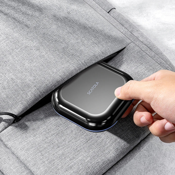 Black case slipped into the pocket of a grey fabric bag
