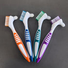 Four double-headed cleaning brushes in orange, blue, green and purple; each brush comes in one colour