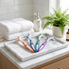 Cleaning brush for aligners and retainers — on a white marble tray in a bright bathroom