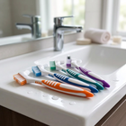 Cleaning brush for aligners and retainers — on the edge of a white washbasin, morning light