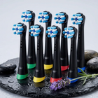 Oral-B iO compatible brush heads — on a wet black slate with pebbles and lavender