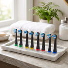 Oral-B iO compatible brush heads — on a white marble tray in a bright bathroom