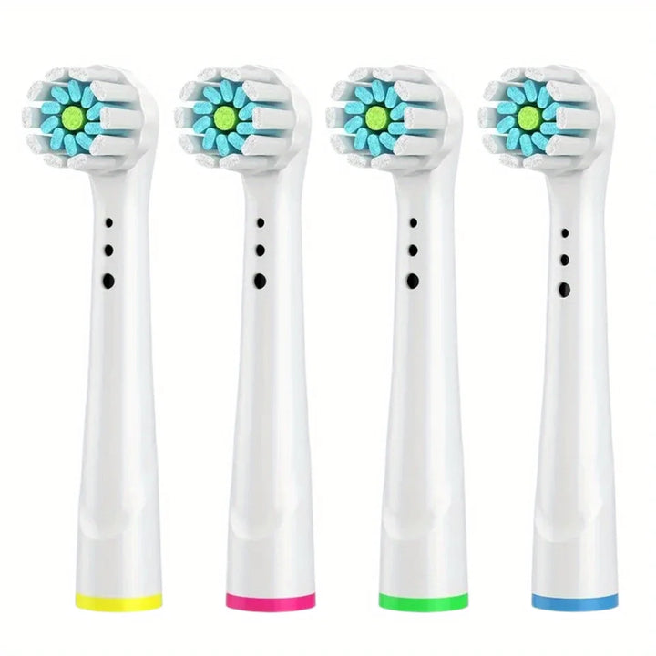 Quattro testine compatibili Oral-B con ciuffo centrale: nucleo verde, ciuffi azzurri a fiore, anelli giallo, rosa, verde e blu