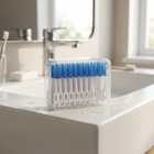 Soft interdental picks — on the edge of a white washbasin, morning light