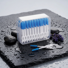 Soft interdental picks — on a wet black slate with pebbles and lavender