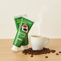 Duo Amante del Caffè ÉclatDent: su un tavolo di legno chiaro con gli ingredienti del pack