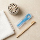 Floss threaders — flat lay on a cream background, minimalist composition