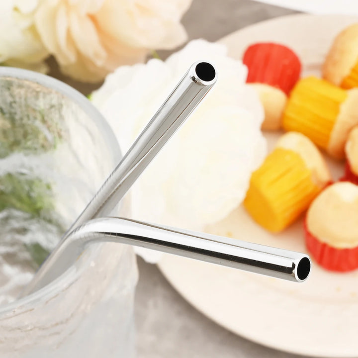 Close-up of the ends of a straight and a bent stainless steel straw