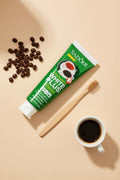 Dentifrice Anti-Taches Café ÉclatDent vu de dessus avec grains de café et brosse en bambou