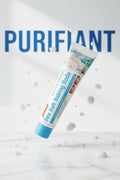 Dentifrice Sel Marin & Bicarbonate ÉclatDent incliné sur fond marbre avec le mot PURIFIANT