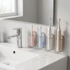 Wall holder for electric toothbrush — on the edge of a white washbasin, morning light