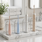 Wall holder for electric toothbrush — on a white marble tray in a bright bathroom