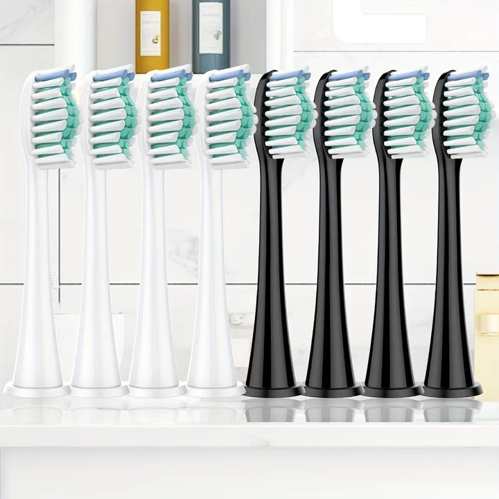 Otto testine compatibili Philips Sonicare in formato DiamondClean, quattro bianche e quattro nere, su una mensola del bagno