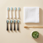 Testine compatibili Sonicare tipo DiamondClean — vista dall'alto su fondo crema, composizione minimalista