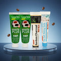 Pack Caffè-Dipendente — 4 dentifrici ÉclatDent: i quattro tubetti su un piedistallo rotondo lucido, sfondo studio blu sfumato