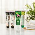 Pack Splendore Carbone — 4 dentifrici ÉclatDent: i quattro tubetti su un vassoio di marmo bianco con spazzolino in legno e asciugamano morbido