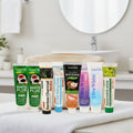 Complete Collection Pack — 8 toothpastes ÉclatDent: the eight tubes packed in a beige toiletry bag on a white towel